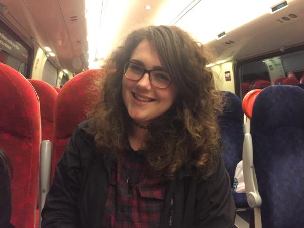 Photograph of Emily Hall on a train.